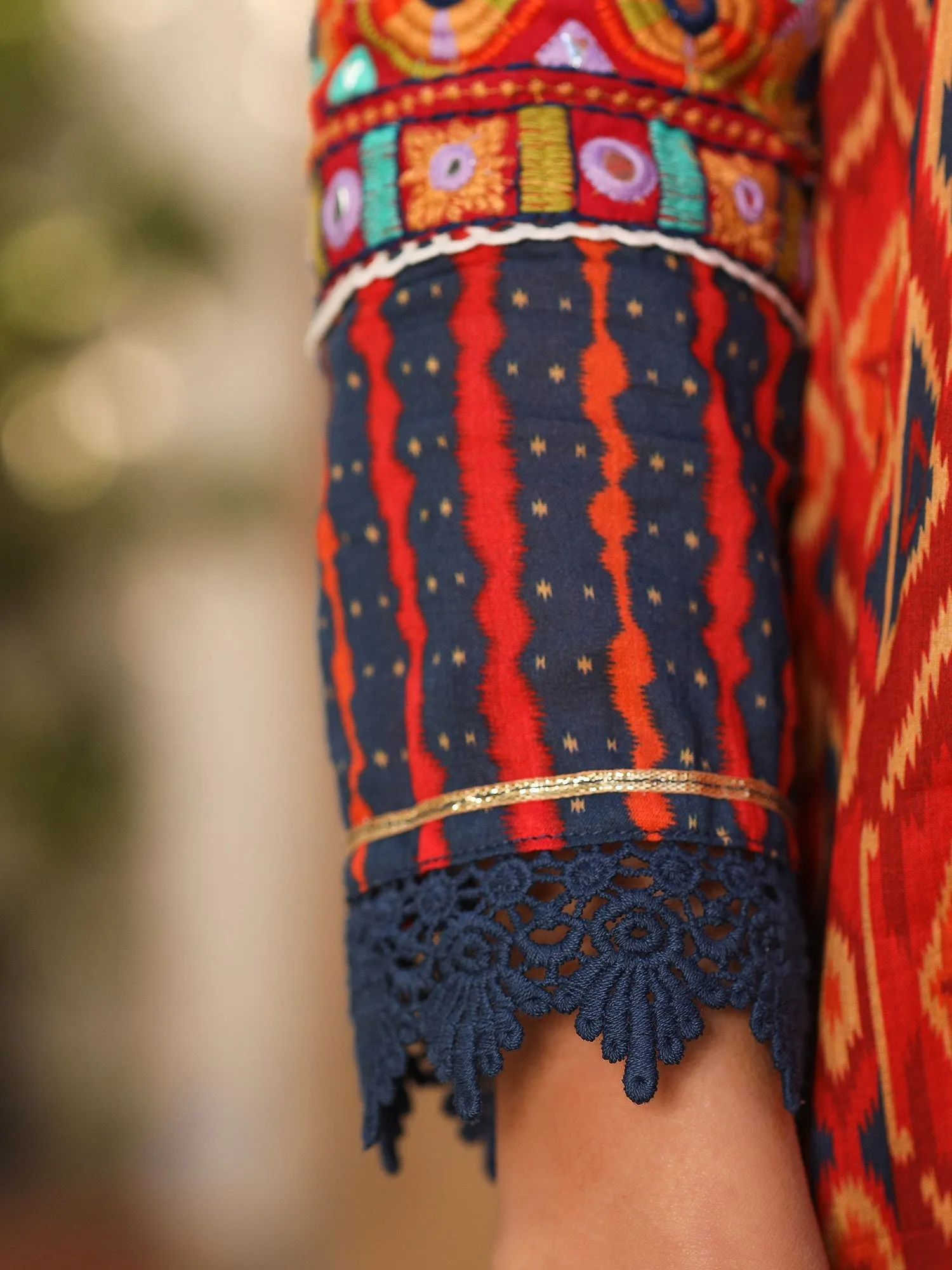 Jashvi Rust Cotton Ikat Printed Layered Maxi Dress With Thread Embroidery & Dori Tassel Tie-Up At Waist