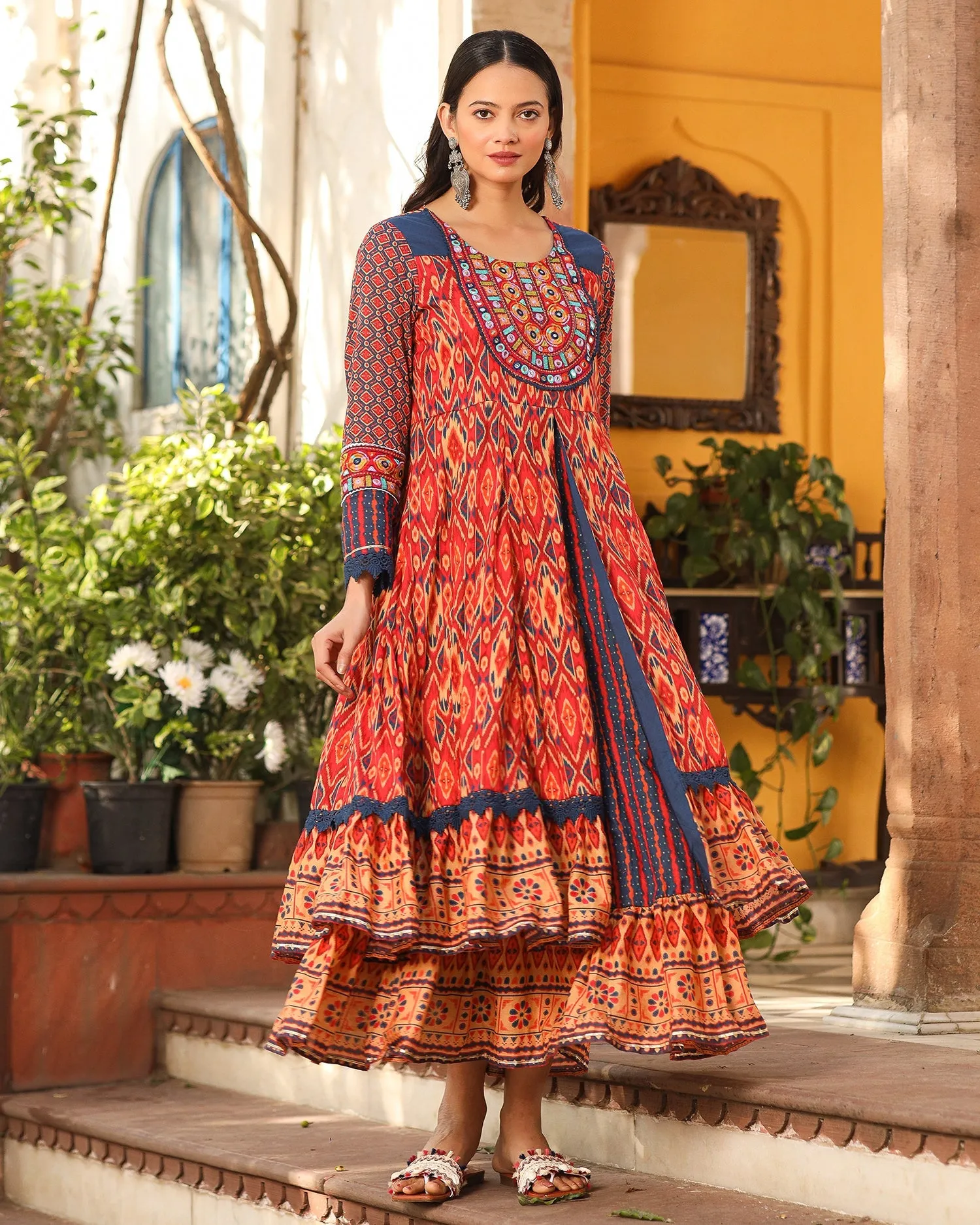 Jashvi Rust Cotton Ikat Printed Layered Maxi Dress With Thread Embroidery & Dori Tassel Tie-Up At Waist
